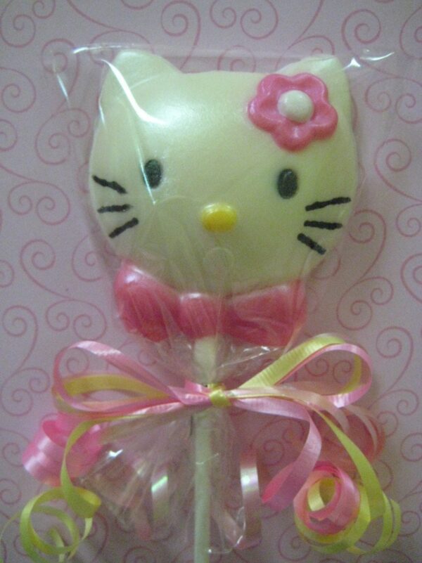 A white chocolate lollipop shaped like a cat face, adorned with a pink bow and ribbon; "12-Say Hello To My Sparkling Kitty Kat White Chocolate Lollipop Favors.