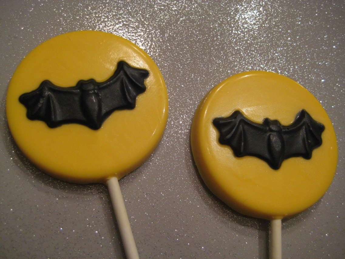 Two chocolate lollipops feature bat designs, perfect as party favors or Halloween treats.