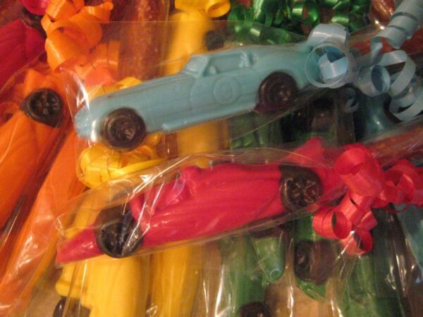 12-Race Car Chocolate Covered Pretzel Rods wrapped in clear cellophane with decorative ribbons.