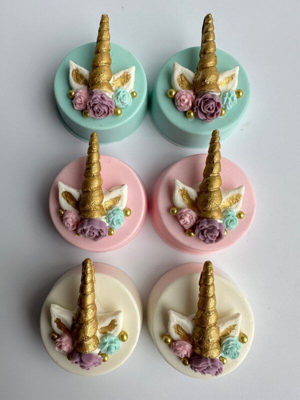 A set of 12 chocolate-covered Oreos adorned with golden unicorn horns, floral designs, and pastel hues in mint, pink, and white for birthdays, baby showers, or weddings.