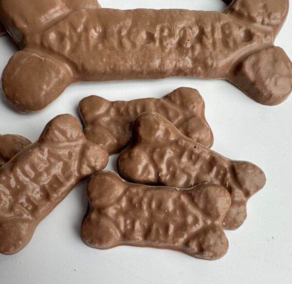 6-Bags of Chocolate Dog Bones for Birthday/Gag Gift/Treats are displayed on a white surface.