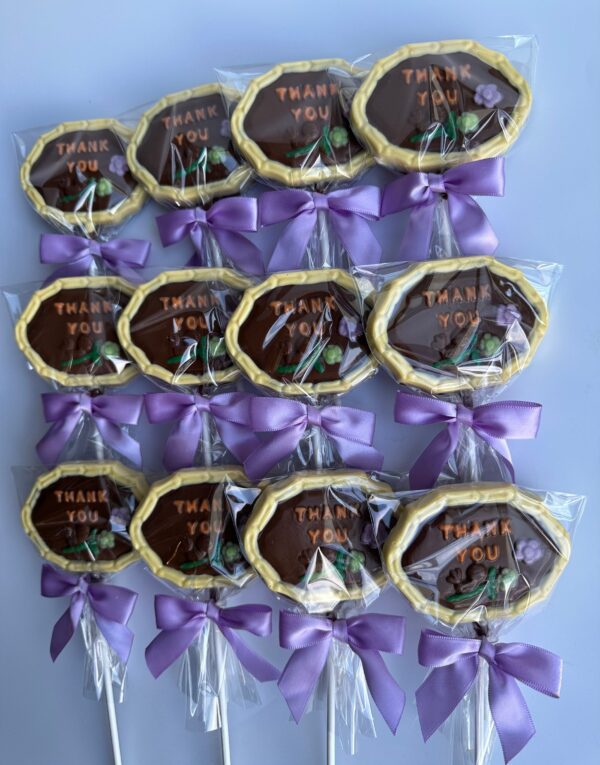 The "12-Thank You Chocolate Lollipops" feature chocolates wrapped in clear plastic, adorned with purple ribbons, arranged neatly on a light surface.