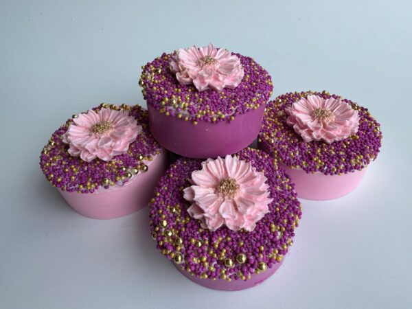 Twelve Fuchsia & Pink chocolate-covered Oreos are topped with pink flowers and multicolored sprinkles, arranged in a pyramid.