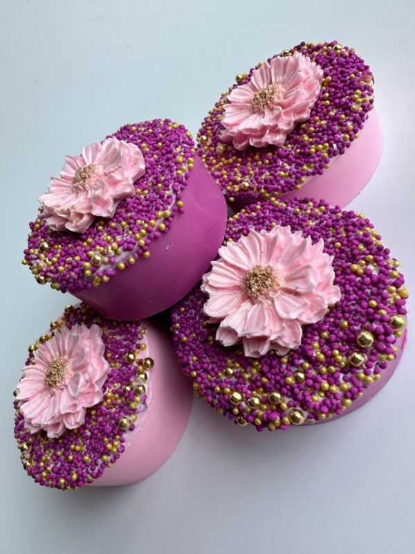 A set of 12 Fuchsia & Pink Chocolate Covered Oreos make perfect wedding, shower, or birthday favors with their decorative pink flower icing and gold bead accents.