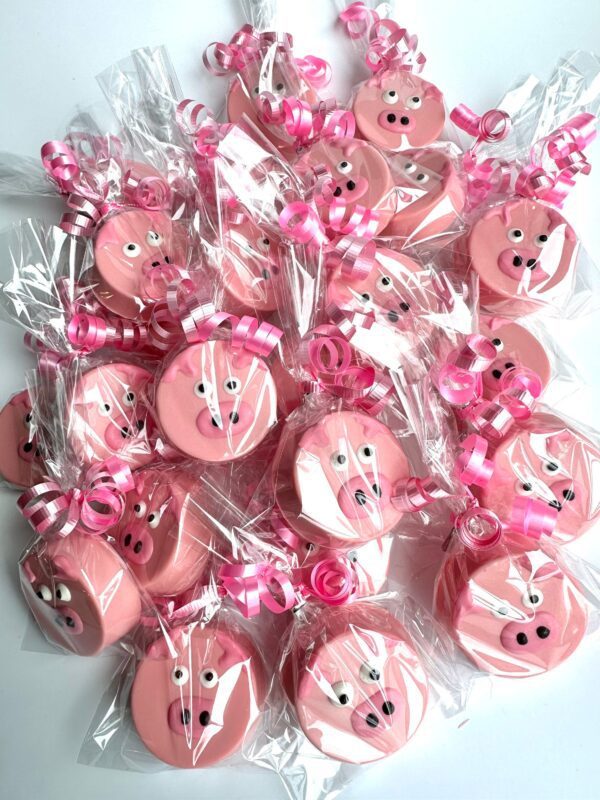 Decorated 24-Pink Pig Chocolate Covered Oreo Favors with faces and curly pink ribbons.