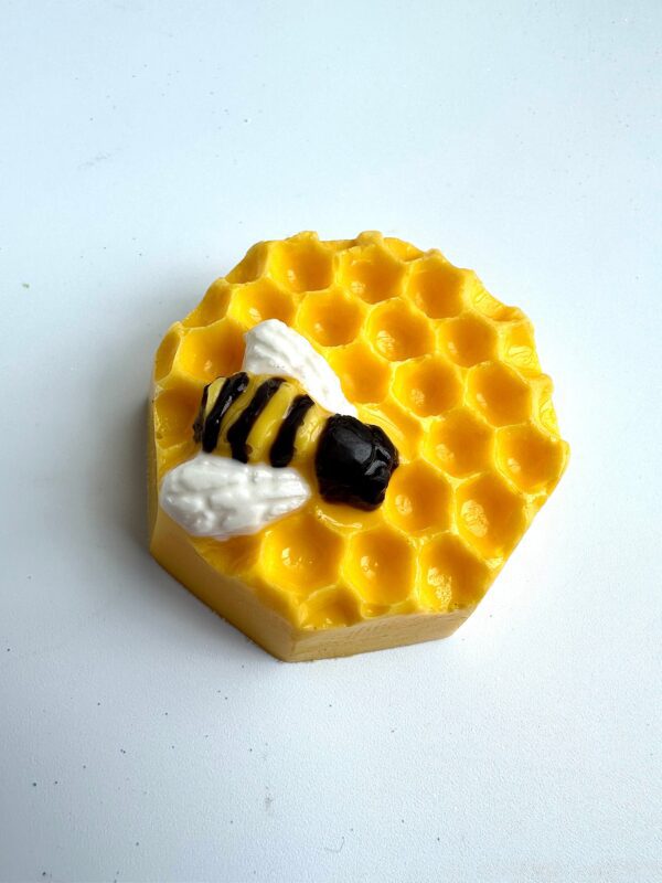 A hexagonal soap resembling the 12-Sweet Honeycomb Chocolate Covered Oreos includes a honeycomb pattern and a small black and yellow bee decoration, perfect for baby showers or party favors.