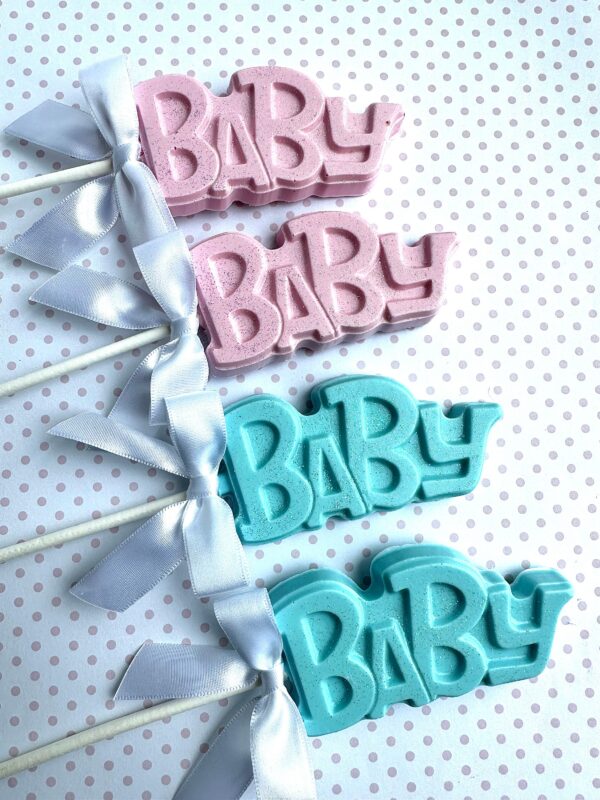 Five "24-BABY Chocolate Lollipops For Baby Shower/Party Favors" in pink and blue with white ribbons, displayed on a polka dot background.