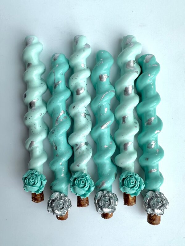 Five of the 12 Tiffany Blue and Silver Chocolate Covered Caramel Pretzels, featuring floral designs and elegant silver accents.
