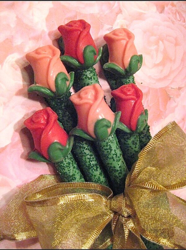 The 24-Long Stem Roses set includes red and peach chocolate-covered pretzel rods with green-stemmed bases, tied together with a gold ribbon. The background showcases a soft pink rose pattern.
