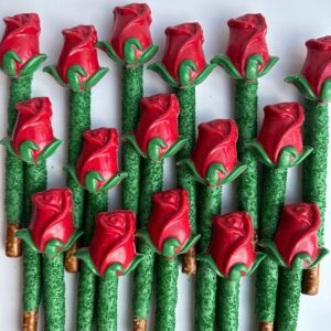 24 long-stem, rose-shaped chocolates cover pretzel rods with green stems on a white background.