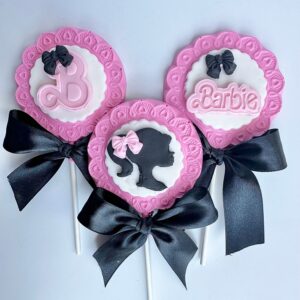 This set includes three lollipops with Barbie-themed designs like silhouettes and text, in pink, white, and black bows.
