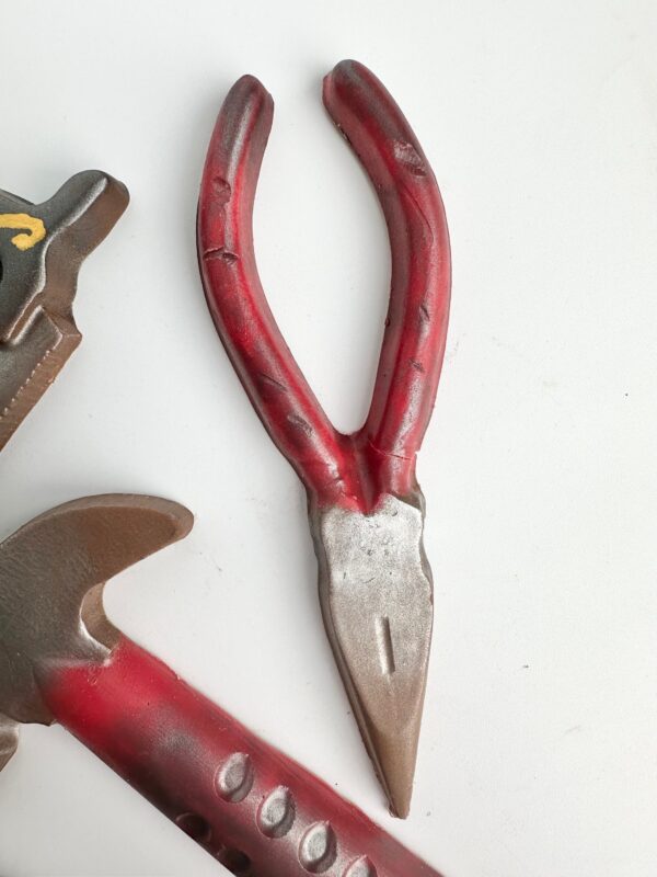 A 5 Piece Chocolate Tool Gift Set, featuring red pliers and a wrench, displayed on a white surface, ideal for Dad's birthday or any special occasion.