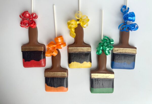 Five Paint Brush Chocolate Lollipops with colorful bows on a white background from the "12-Paint Brush Chocolate Lollipops For Birthday Party/Party Favors" set.