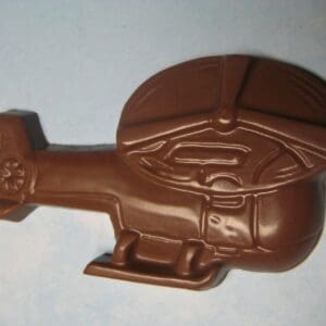A 12-chocolate helicopter favor, featuring detailed rotor blades, tail, and landing skids set against a light blue background.