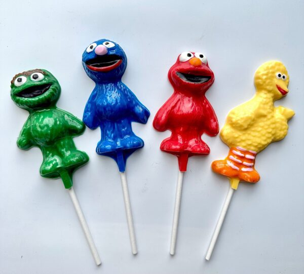 Four 12-assorted Sesame Character lollipops are lined up on a white background, perfect for birthday or children's party favors.