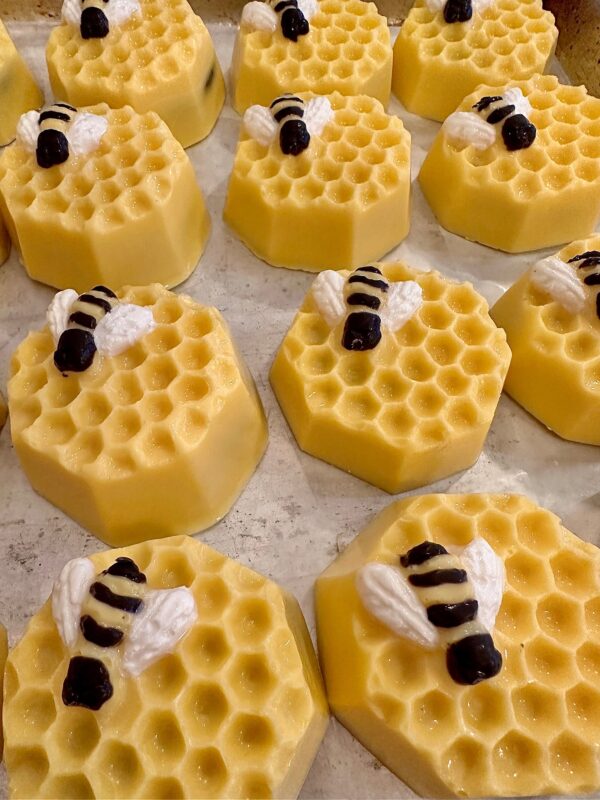 12-Sweet Honeycomb Chocolate Covered Oreos, featuring bee figures on top, arranged in rows. Perfect for baby showers, birthdays, or party favors.