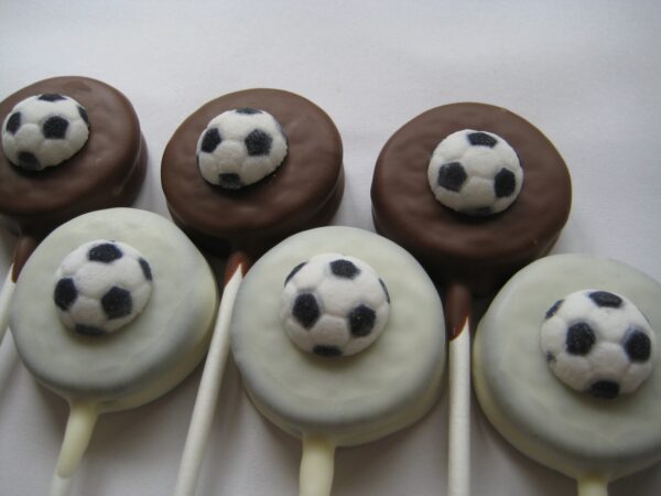 Five 12-Soccer Ball Chocolate Covered Oreo Lollipops arranged in a row on a white background.