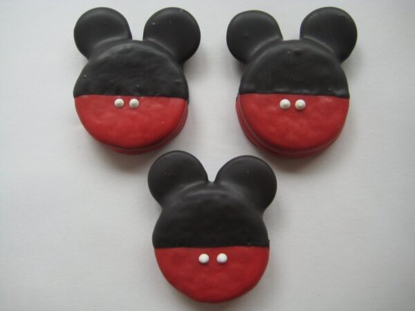 Three Mickey Mouse Chocolate Covered Oreos with black ear shapes and red bottoms, each featuring two white dots.
