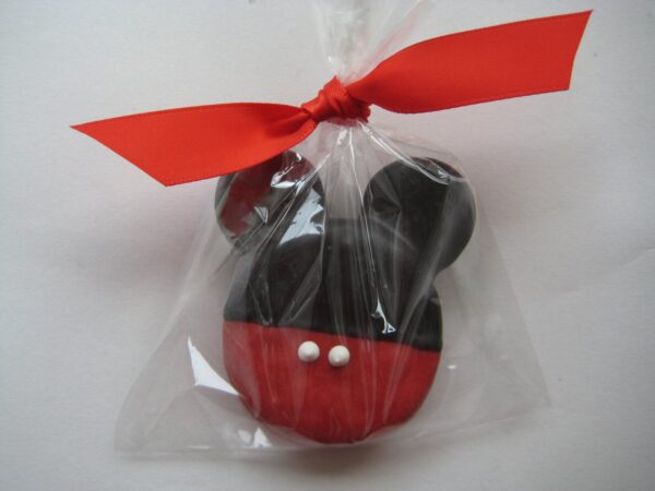 A plastic bag with a red bow contains an Oreo shaped like a mouse head.