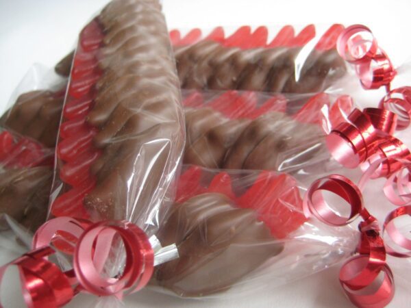 24-chocolate covered Swedish Fish favors, wrapped in clear plastic with red and pink ribbon curls.