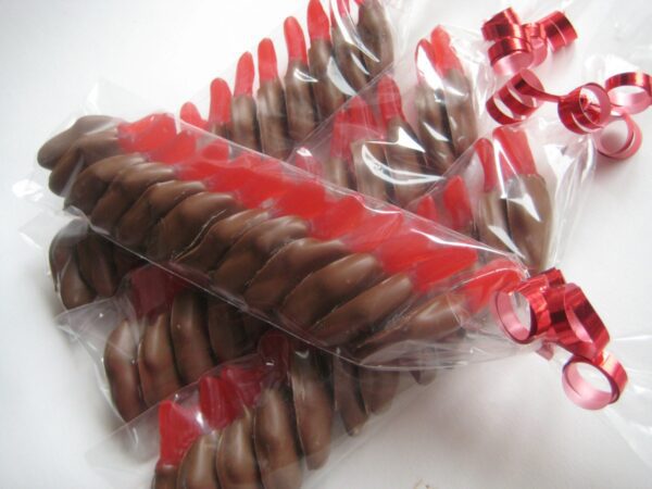 24 chocolate-covered Swedish Fish favors wrapped in clear plastic with red ribbon ties.