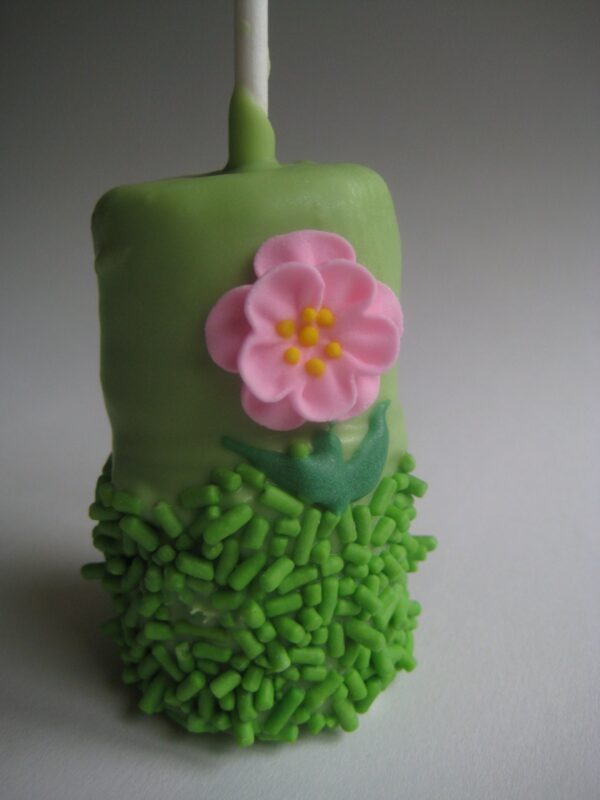 Green double chocolate marshmallow pop with green sprinkles and a pink flower decoration from the 12-Flower Garden Themed set.