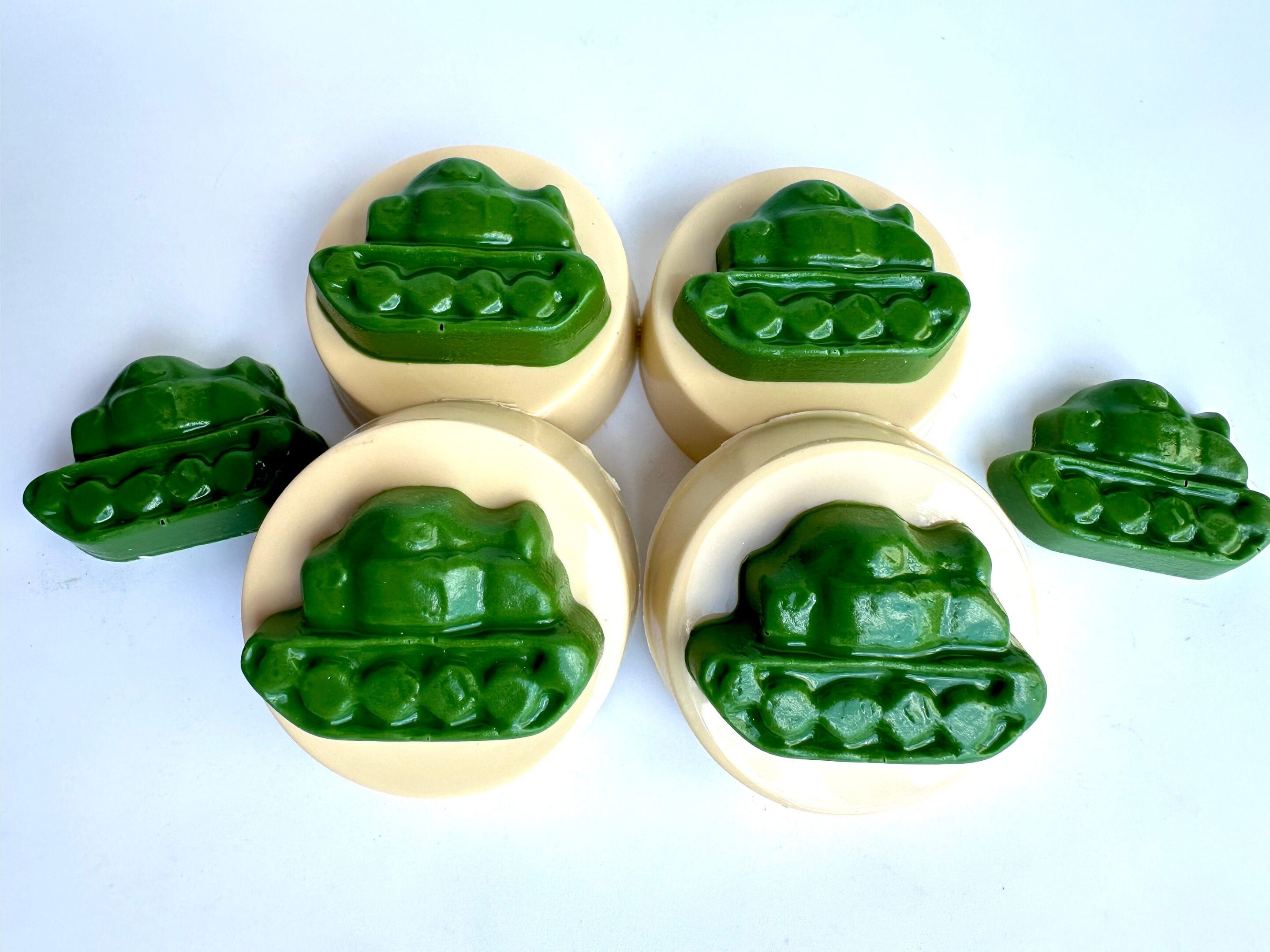 Chocolate-covered Oreos with green military tank designs on a white background for parties or gifts.