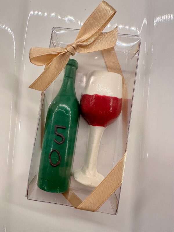 A clear box with a tied bow contains 12 chocolate wine glasses and wine bottles, perfect for birthdays, anniversaries, or weddings.