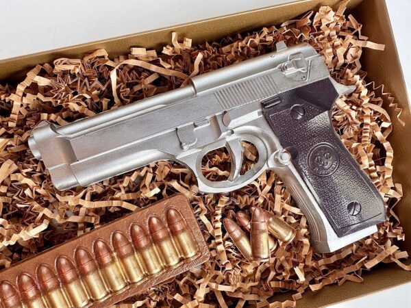 A realistic toy gun made of chocolate, complete with chocolate ammo and wrapped in crinkled paper inside a box, named "Chocolate Hand Piece Boxed Gift For Birthday Gift/Dad Gift/Son Gift/Police Officer.