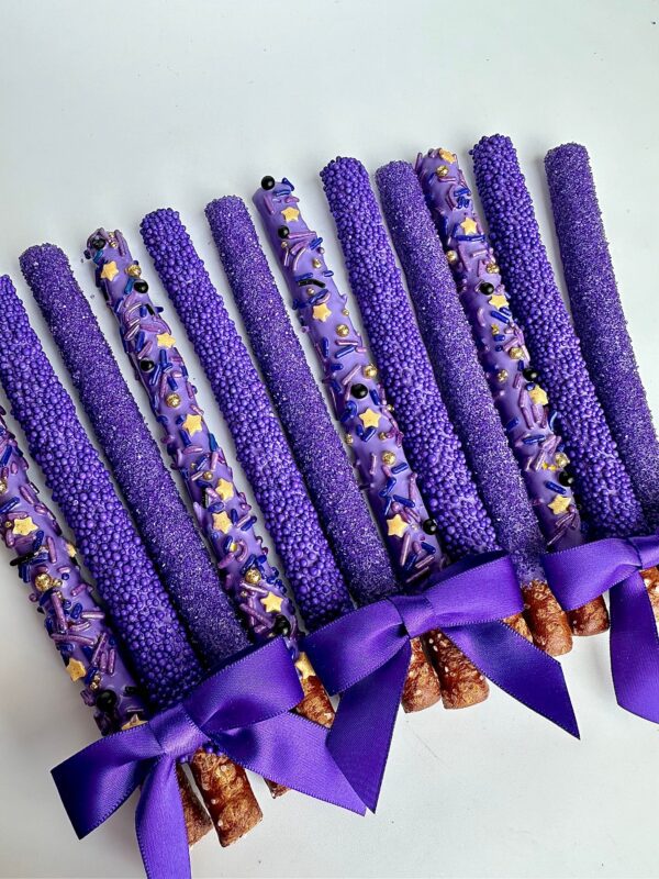 The "12-Pretty Purple Pretzels For Birthday Party/Party Favors/Wedding Favors" are arranged in a row on a white surface, featuring sprinkles and bows.