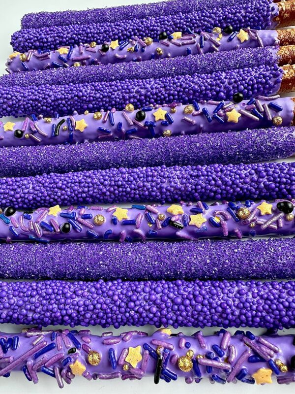 Rows of pretzel rods from "12-Pretty Purple Pretzels For Birthday Party/Party Favors/Wedding Favors" are coated in purple decorations including sprinkles, glitter, and star-shaped candies.