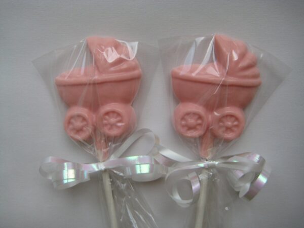 Two baby carriage lollipops, wrapped in clear plastic with white ribbon bows, perfect for a baby girl shower.