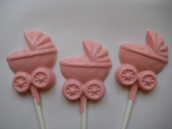 Three chocolate baby carriage-shaped lollipops for a baby girl shower on a white background.