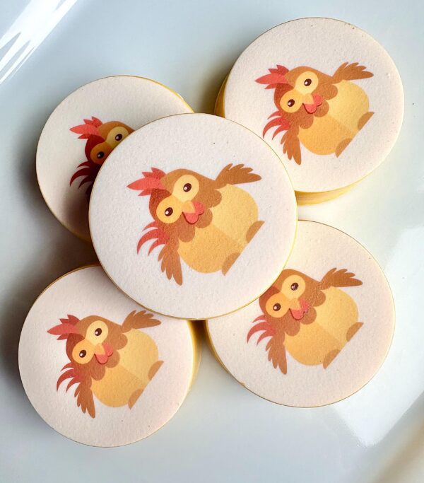 Five round chocolate-covered Oreos featuring a baby chicken design, ideal for birthday parties or baby showers.