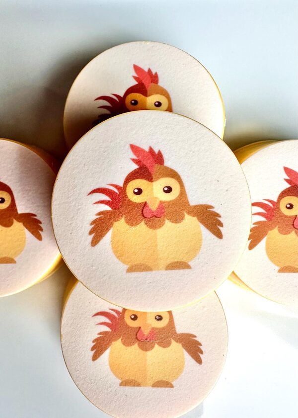 Round coasters designed like baby chicken chocolate-covered Oreo favors, featuring brown wings and red combs, perfect for birthdays or baby showers.