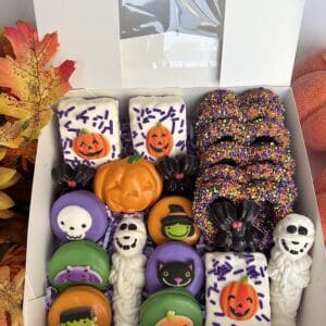 Halloween-themed cookies and treats in box.