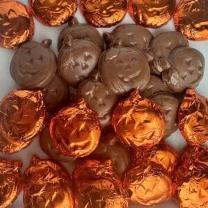 Pumpkin-shaped chocolates in orange foil wrappers.