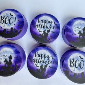 Purple Halloween-themed tins with spooky designs.