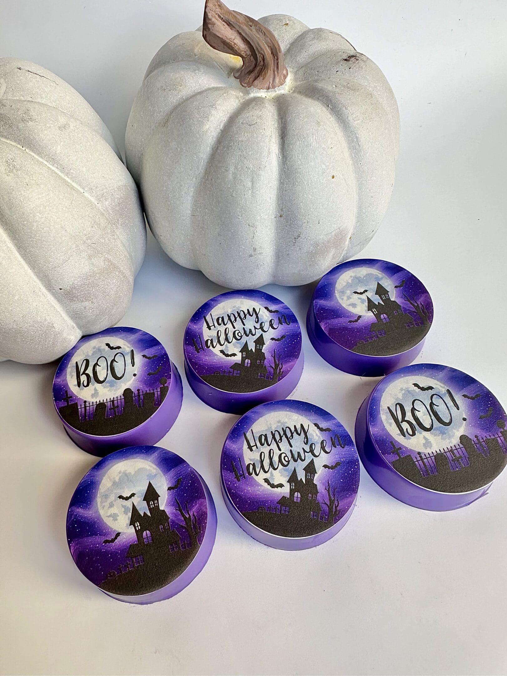 Halloween-themed cookies with white decorative pumpkins.