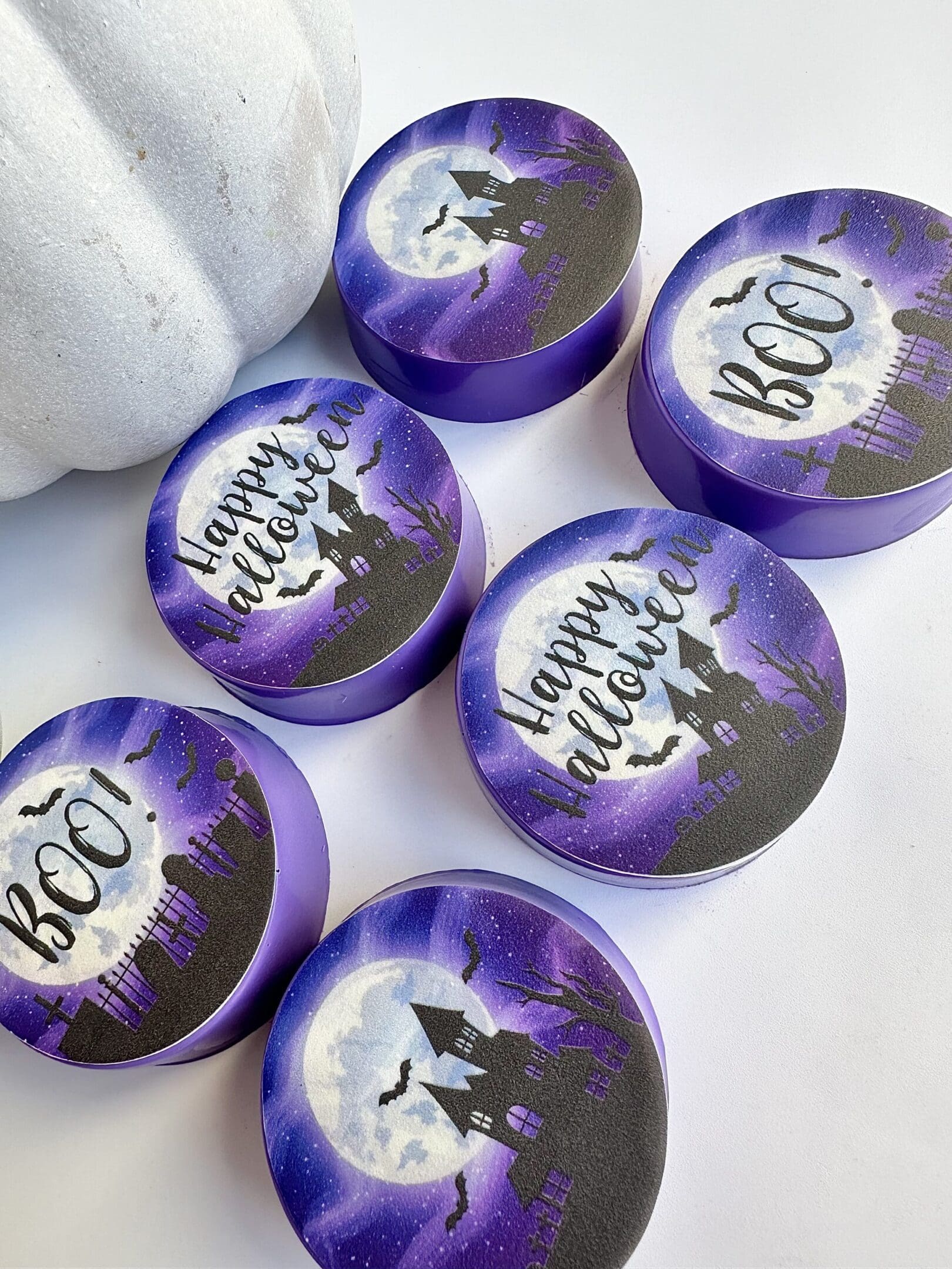 Purple Halloween-themed round containers, moon design.