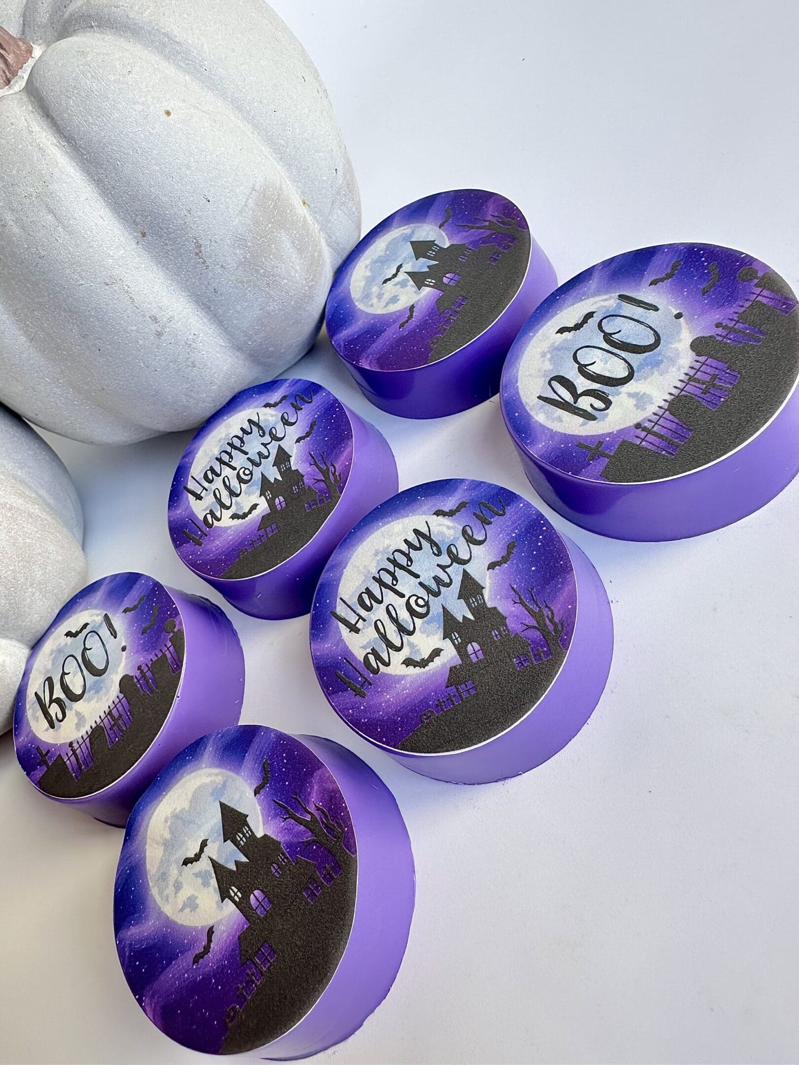 Purple Halloween-themed soaps with white pumpkin.