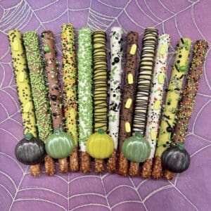 Halloween-themed decorated chocolate-covered pretzel sticks.