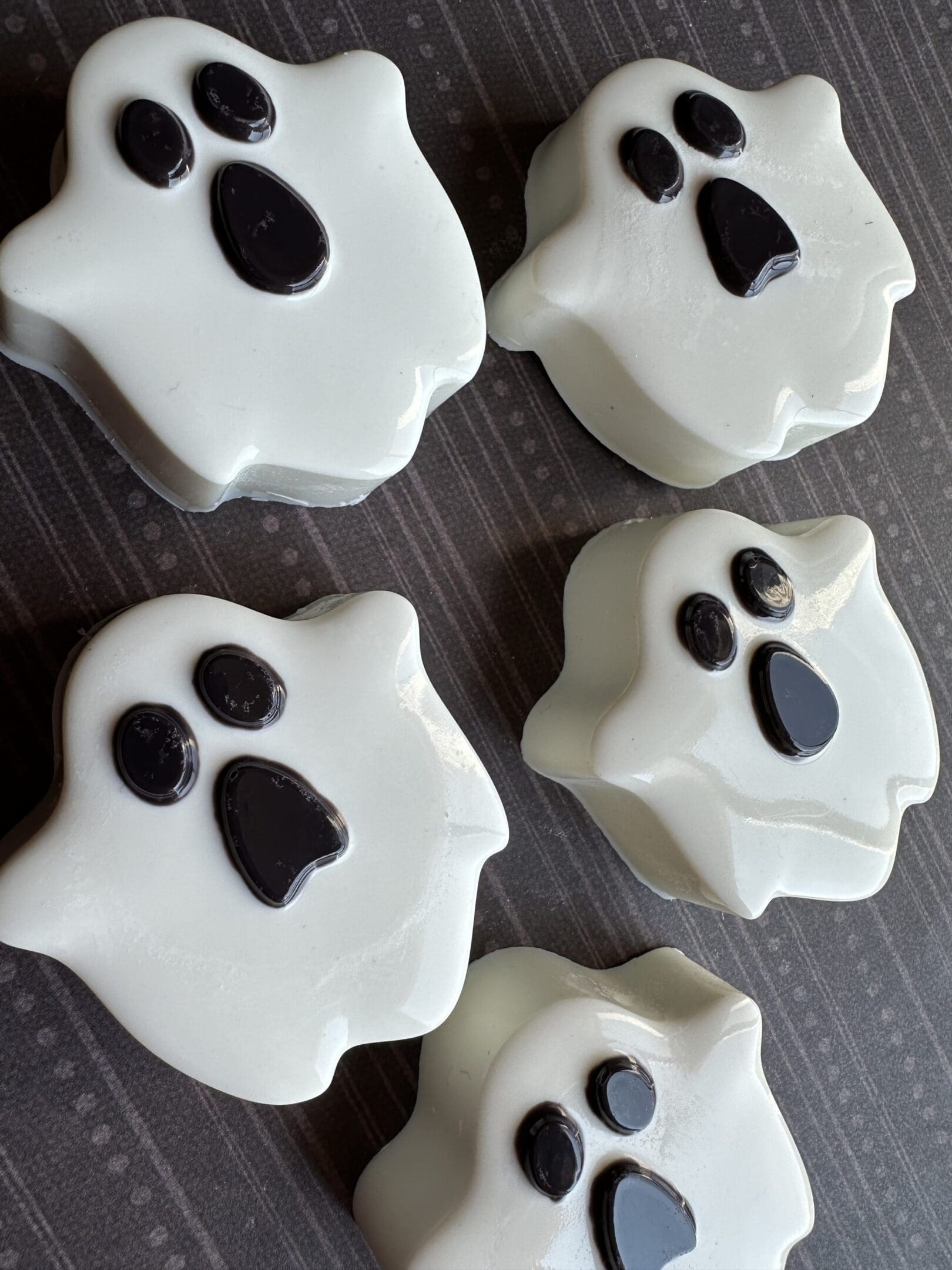 Ghost-shaped cookies with black eyes and mouths.