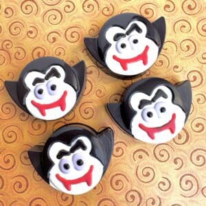 Vampire cupcakes on a swirled pattern background.