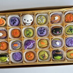 Halloween-themed decorated chocolates in a box.
