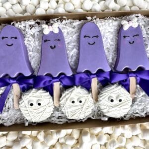 Purple ghost and mummy-themed cake pops.