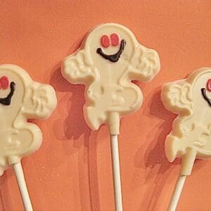 Three ghost-shaped white chocolate lollipops.